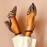 Zebra-print pointed toe pumps with ankle strap